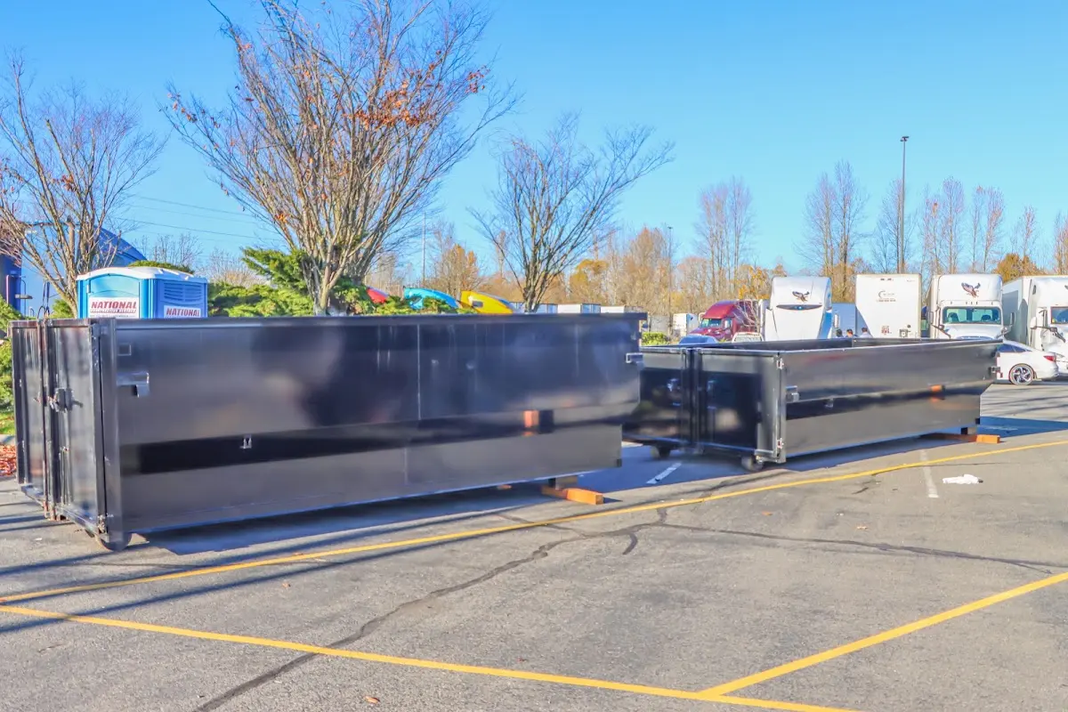 Professional dumpster rental service with roll-off container on residential driveway in Maple Heights